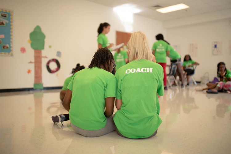 Coach and girl sitting together